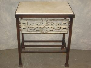 Ferro Designs LLC custom iron bedside table with a dark iron base finish, a white, distressed cast iron inset, and a travertine tile top.
