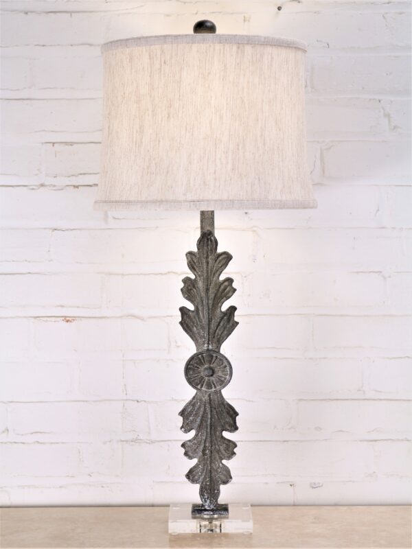 Leaf custom iron table lamp with a gray, distressed finish on an acrylic base. Paired with a 12 inch linen drum lamp shade.