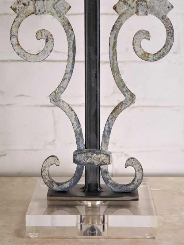 Scroll custom iron table lamp with a white, distressed finish on an acrylic base