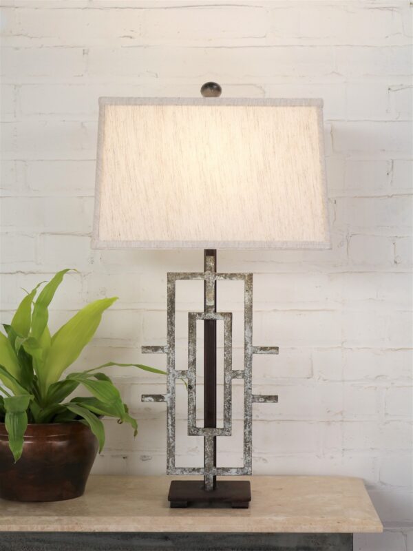 Geometric custom iron table lamp with a gray, distressed finish on a dark iron base. Paired with a 14 inch rectangle linen lamp shade.