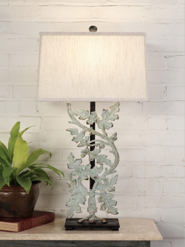 Oak leaves custom iron table lamp with a patina green finish and a dark iron base. Paired with a 16 inch rectangle linen lamp shade.