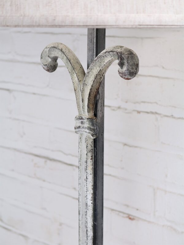 Scroll column custom iron table lamp with a white, distressed finish.