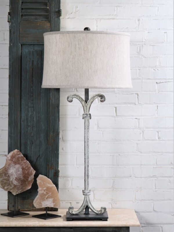Scroll column custom iron table lamp with a white, distressed finish and a pewter base. Paired with a 17 inch linen drum lamp shade and selenite crystal decor.