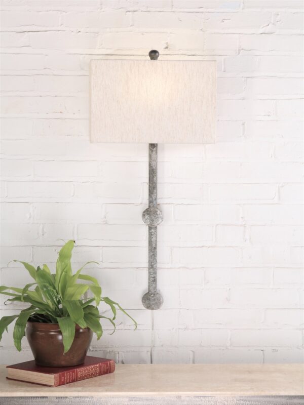 Small sphere custom iron wall sconce with a gray, distressed finish. Paired with a half rectangle linen lamp shade.