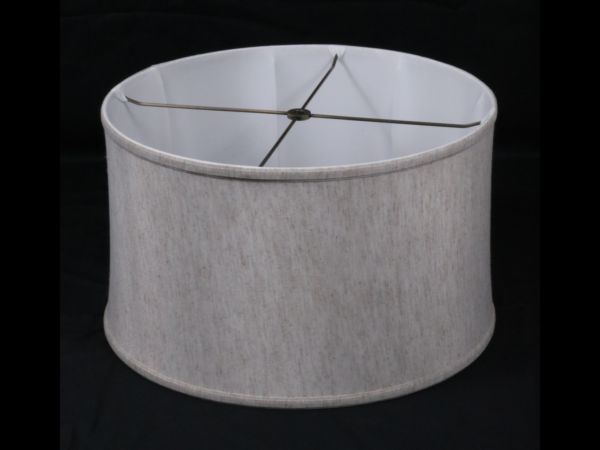 Drum shaped linen lamp shade on a black background