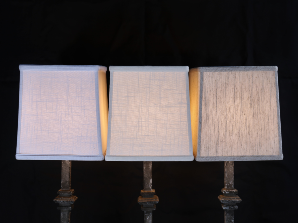 Linen lamp shades on a black background
